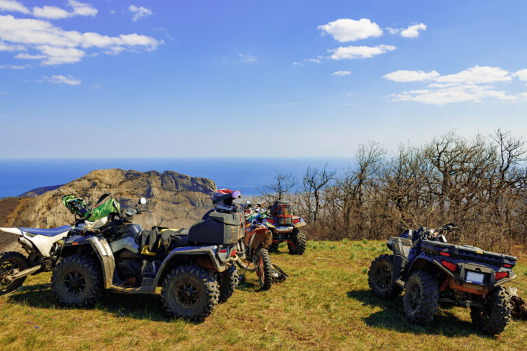 Quad ATV cars all terrain vehicle parked on mountain road