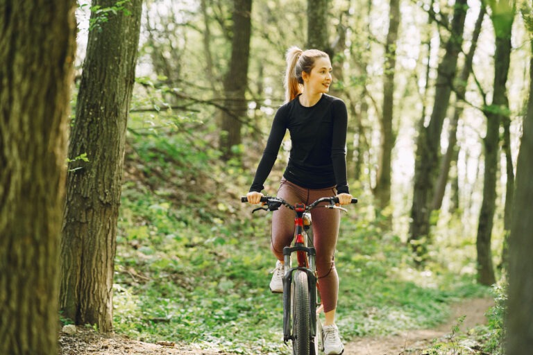 Woman riding a mountain bike in the forest